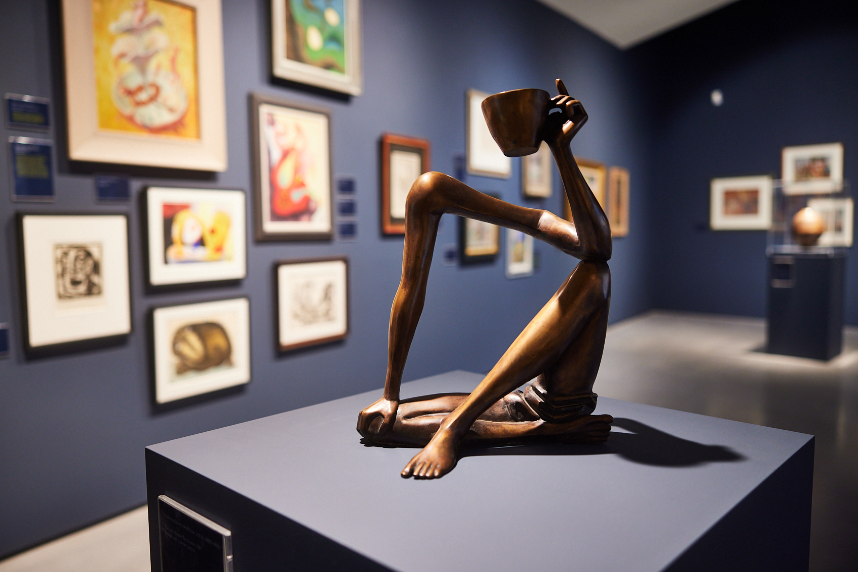 Image: Installation view at The Hepworth Wakefield © David Lindsay 2022 - photosbydavid.co.uk Artwork in foreground: Frederick Edward McWilliam, The Left Handed Tea Drinker, 1981, bronze. The Sherwin Collection, Leeds, UK. By kind permission of the Estate of F E McWilliam.