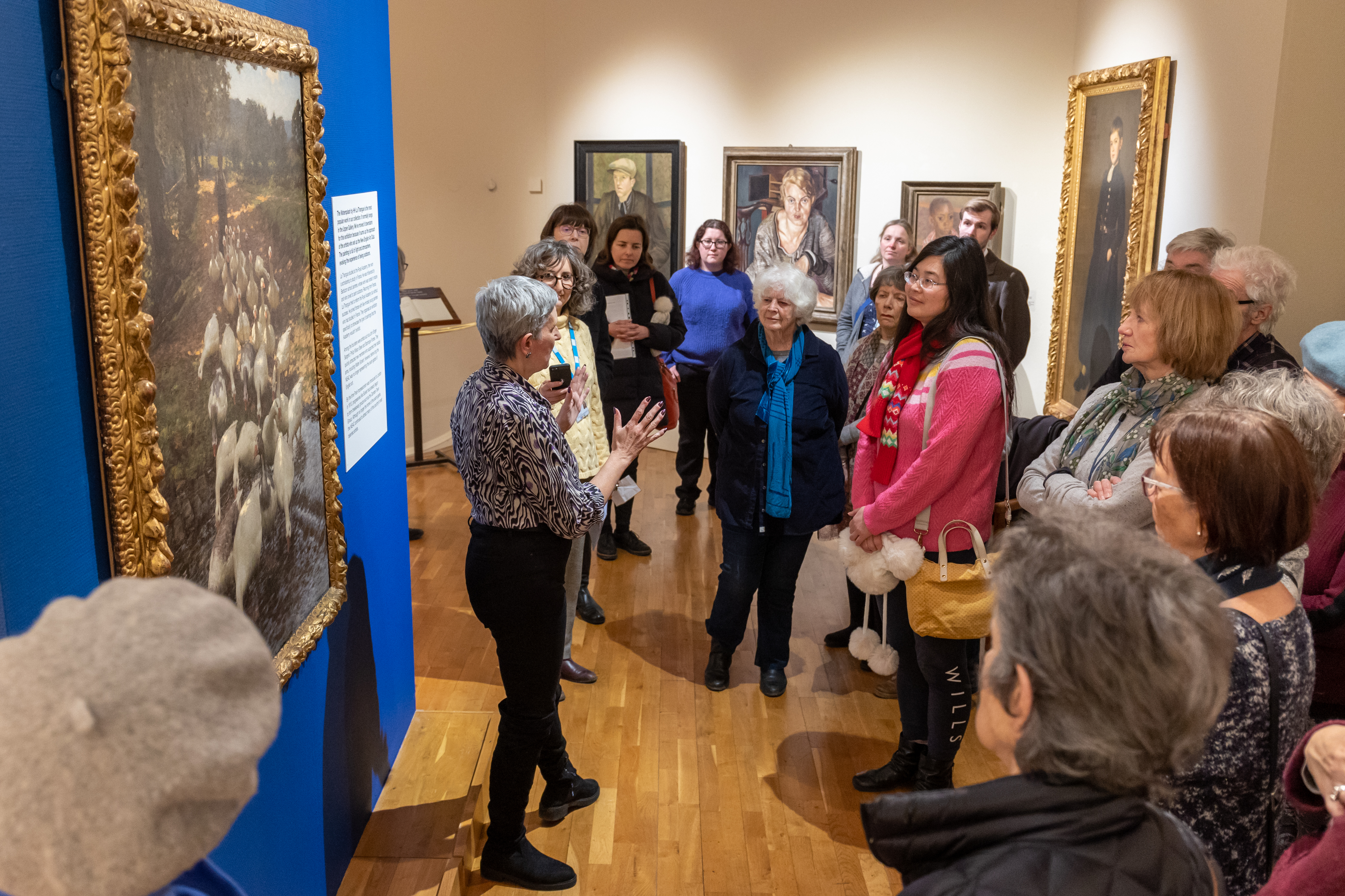 Image: A curator giving a tour of an exhibition at the Gallery
