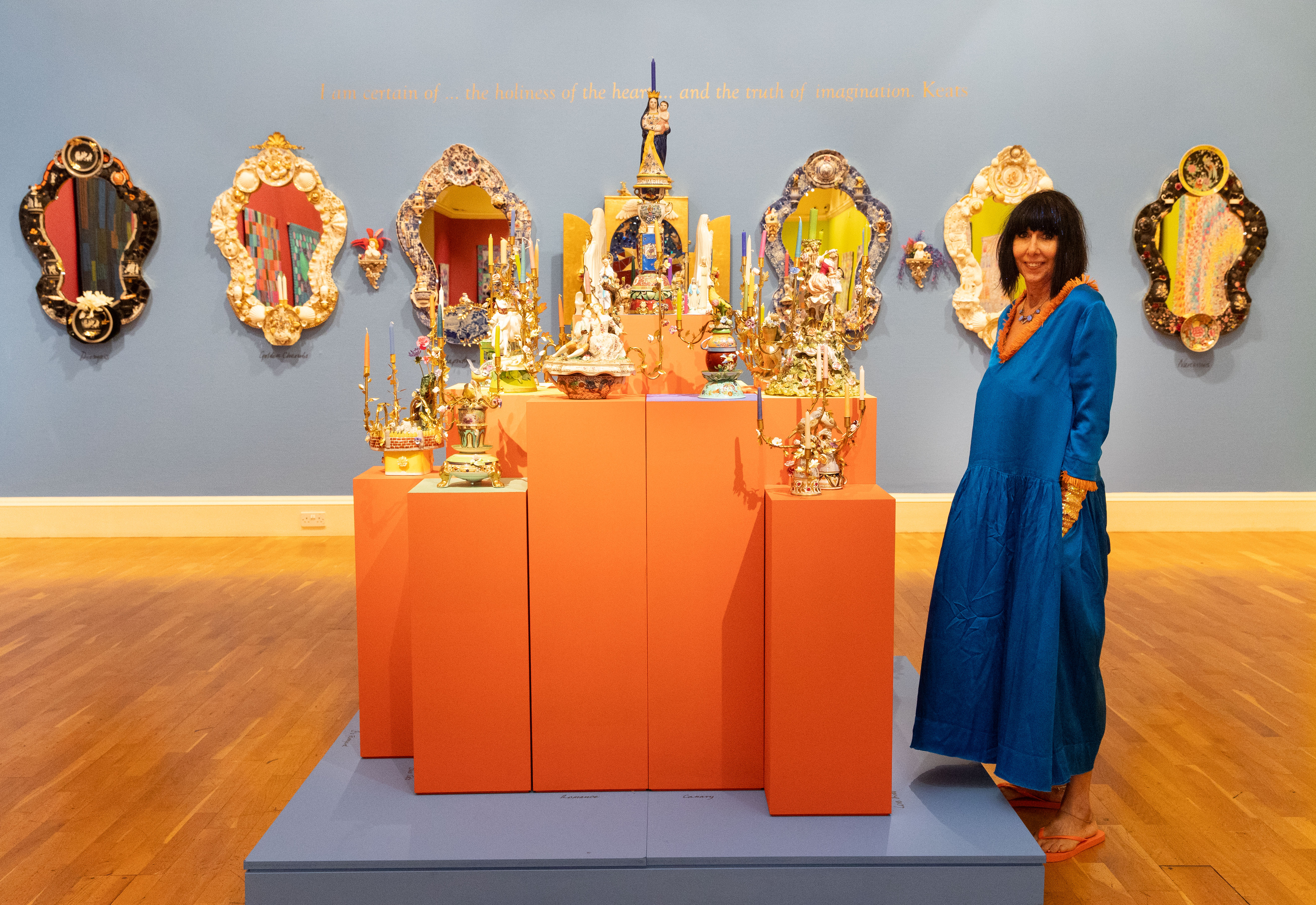 Image: Candace standing next to her artworks