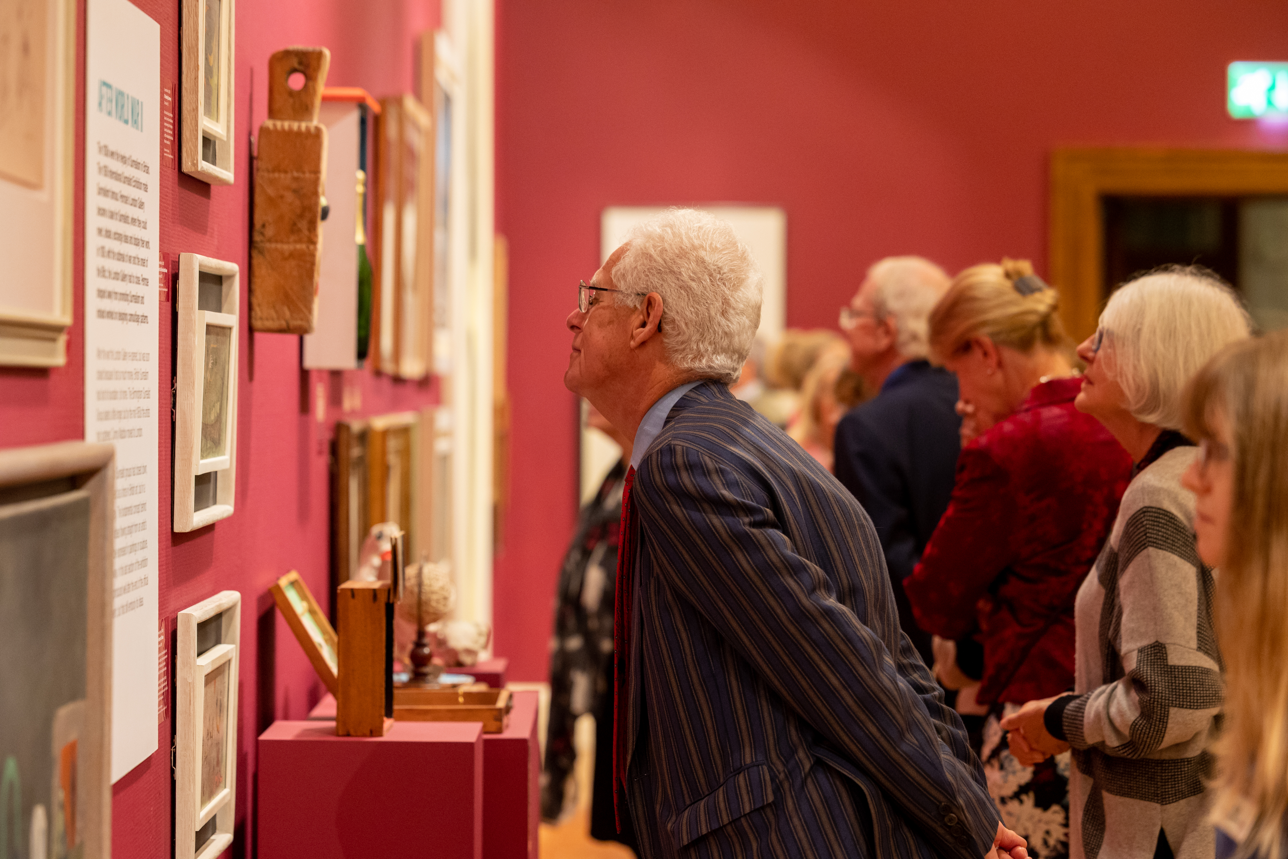 Image: A group of people looking at the Surrealism exhibition