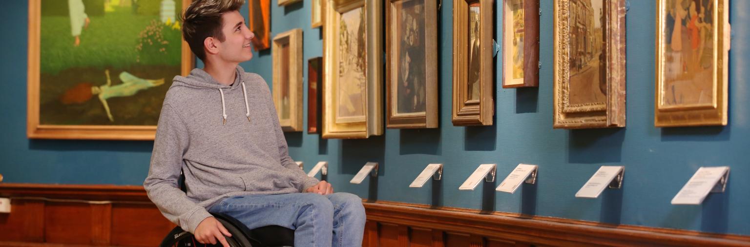 Image: A visitor viewing artwork in the permanent collection