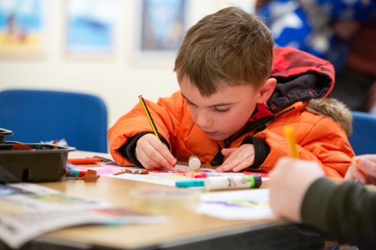 Image: A child taking part in a craft activity